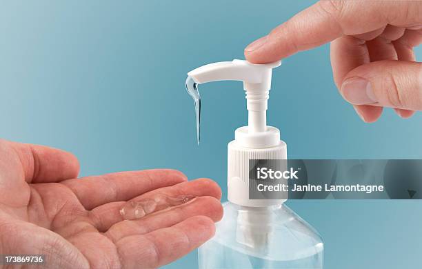 Photograph Of A Finger Pumping Sanitizer Onto Hand Stock Photo - Download Image Now - Hand Sanitizer, Disinfection, Cleaning Product