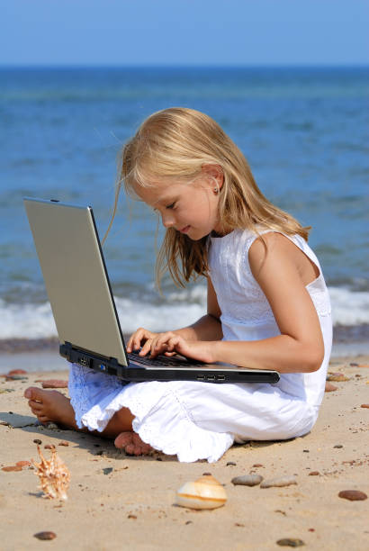 istock Girl with laptop on the beach 173869978