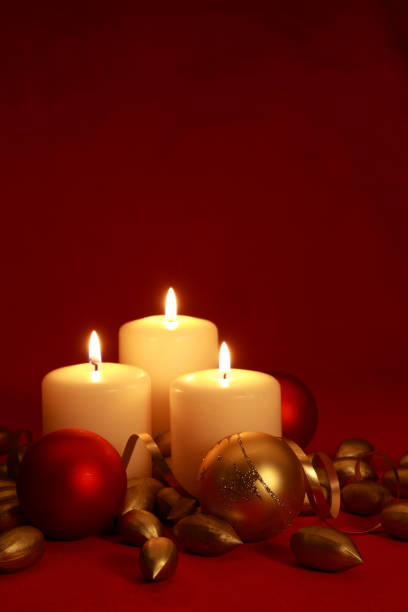 istock Christmas candles, baubles, ribbon and gold nuts on  red backdrop. 173870292