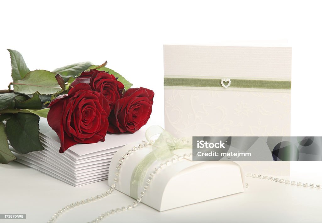 Preparations for Wedding "Homemade wedding invitation cards with green ribbon and pear heart, confetti box and red roses.See also:" Celebration Stock Photo