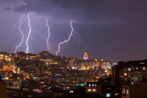 A powerful electric shock hits the city center with multiple lightning strikes near the Istanbul Galata tower.