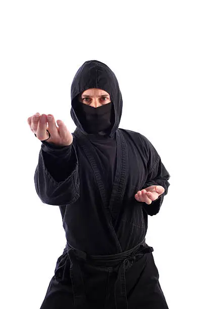 A ninja on a white background executes a knife-hand strike.