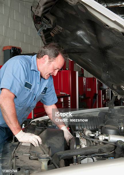 Auto Mechanic Working Under Hood Stock Photo - Download Image Now - Adult, Adults Only, Auto Mechanic