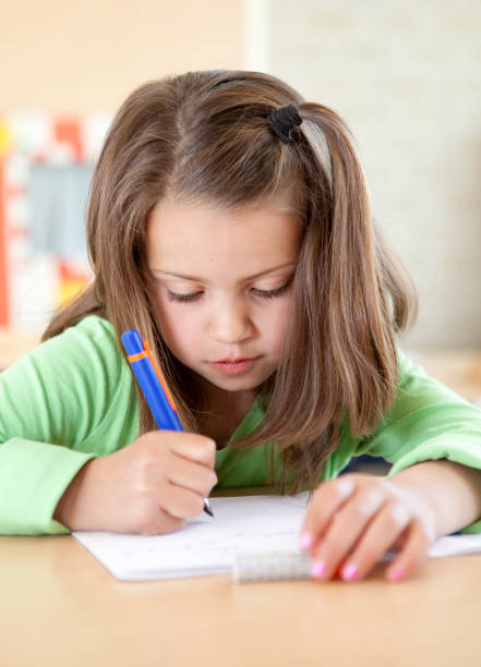 istock Young female child writing 173872231