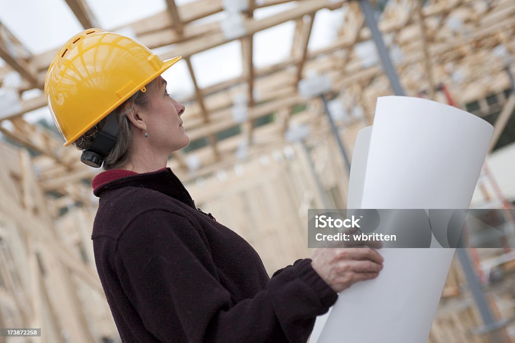 Professional woman at construction site (XXL) "Attractive woman in professional role as architect, inspector, etc. at a construction site." Adult Stock Photo