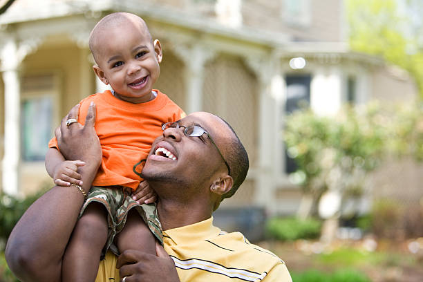 istock african american father holding his son on shoulders 173872505
