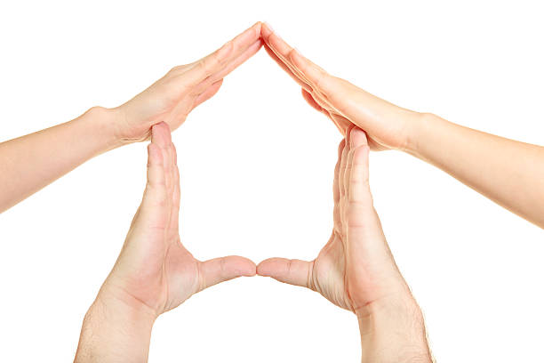istock Home sign made up of four hands 173872654
