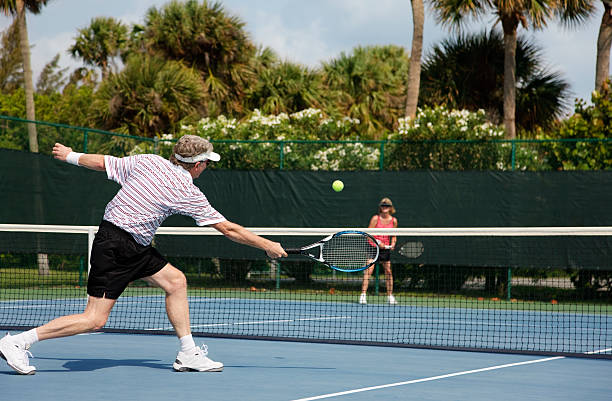 senior couple playing tennis