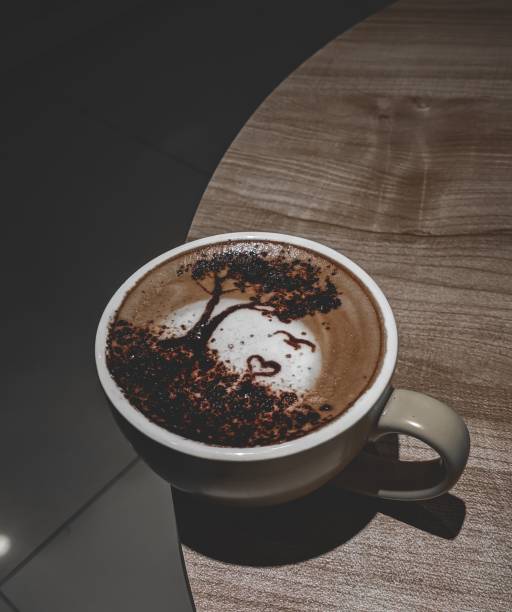 a white cup on a table with brown and white paint