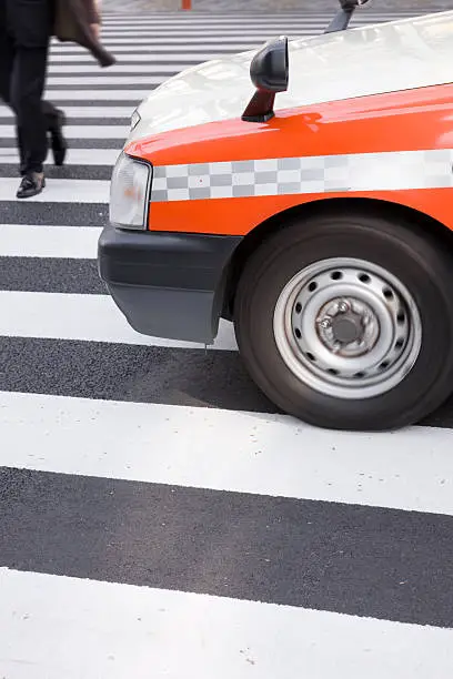Dangerous Street Crossing in Front of Taxi Vehicle somewhere in Tokyo, Japan.