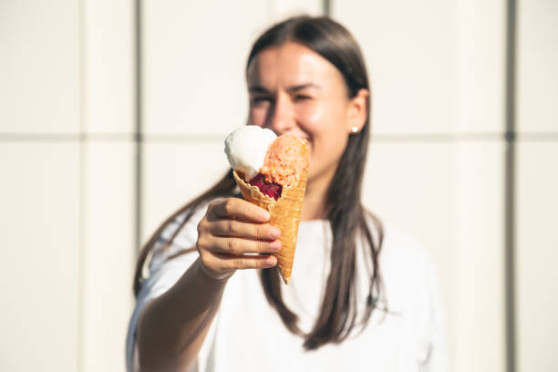 istock An appetizing ice cream cone in female hands. 1738741959