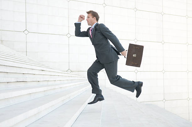 istock Businessman Rushes Up White Staircase 173875236