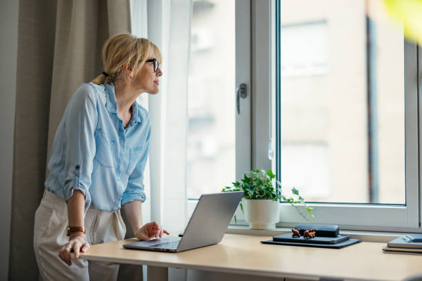 istock A Happy Beautiful Blonde Businesswoman Looking Away While Working On Her Computer 1738752572