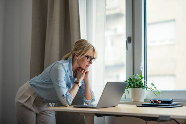 A Serious Beautiful Blonde Businesswoman Working On Her Computer