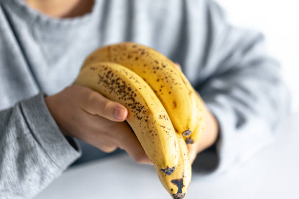 istock Ripe yellow bananas in female hands on a blurred background. 1738762261