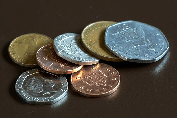 istock British coins on dark brown background 173876319