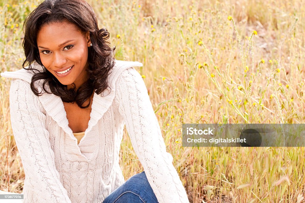 Beautiful African American woman in a meadow 20-29 Years Stock Photo