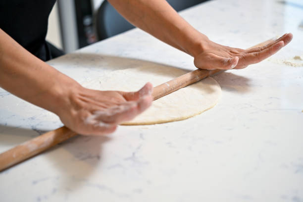 istock Housewoman rolling dough 1738774960