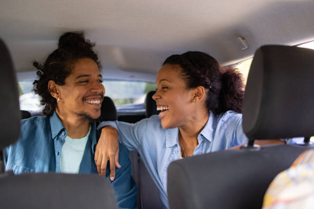 istock Happy black couple talking while riding in a taxi. 1738776329