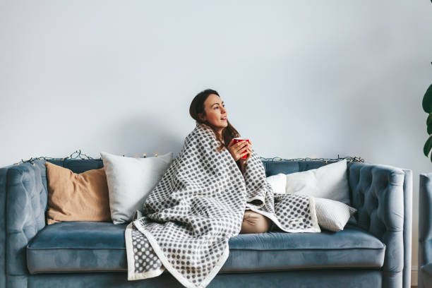 istock A woman enjoying a quiet moment on the couch with a cup 1738776411