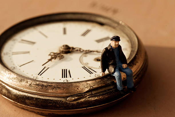 istock Little old man sitting on a pocket watch 173877692