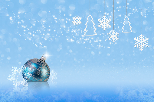 abstract Christmas and New Year concept with christmas decorations, snow, snowflakes and stars on blue delicate background