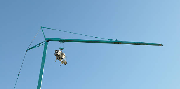cement mixer suspended from crane
