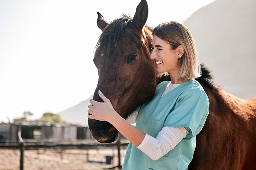 Horse doctor, care and hug outdoor at farm for health, smile and happy with love for animal in nature. Vet, woman and equine healthcare expert in sunshine, countryside and helping for wellness