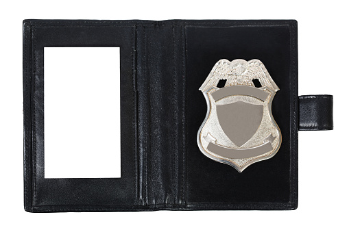 Police badge and blank identity card in a police officer wallet.