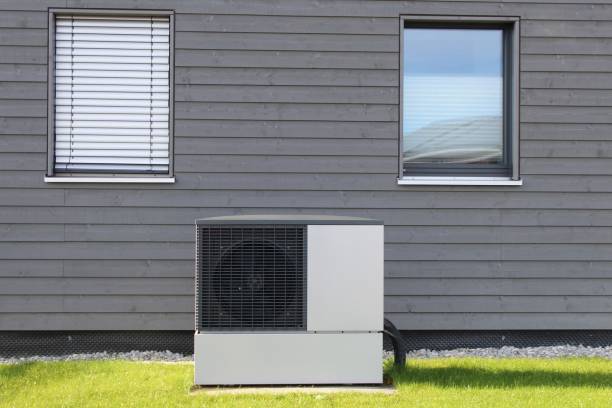 istock Modern detached house with a heat pump in the front garden. A climate-friendly method of heating. 1738790262