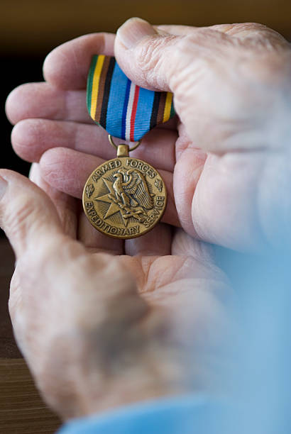 istock Senior hands with a military medal 173879374