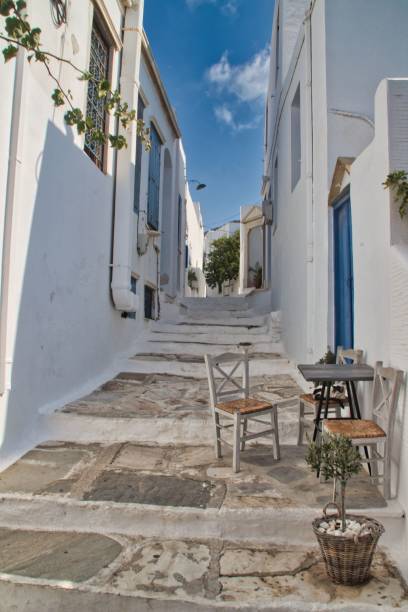 istock Vibrant, narrow alleyway with two chairs with table illuminated by bright sunlight 1738793752