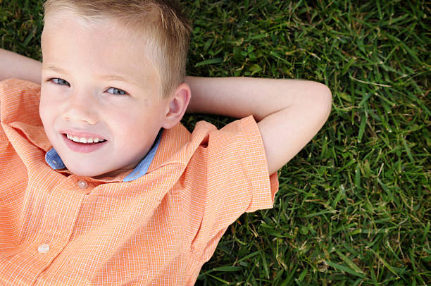istock Little Boy Relaxing in the Grass 173879482