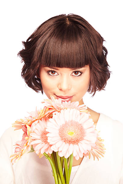 istock Attractive Young Brunette Woman Smiling and Holding Gerbera Daisies 173880751