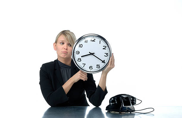 istock sad looking woman holding office clock 173880759