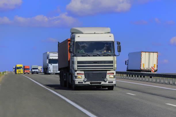 istock Trucks move along a suburban highway 1738810153