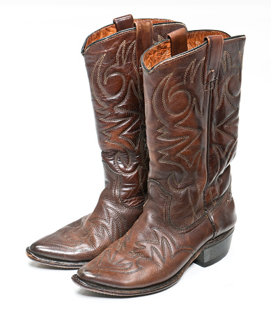 Worn brown leather cowboy boots.