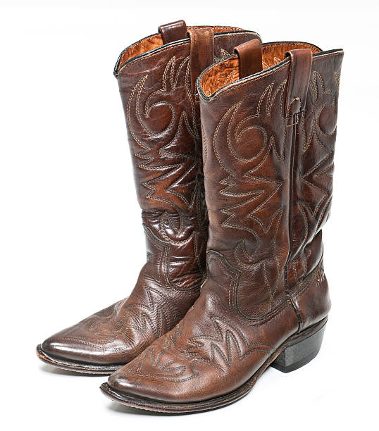 Brown leather cowboy boots with designs stock photo