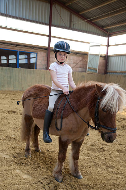 istock little girl and pony 173881229