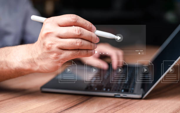 istock Man using hand and keyboard for streaming online on virtual screen, watching video on internet, live concert, show or tutorial, content online. Businessman making video content of business 4.0 in 2023 1738826165