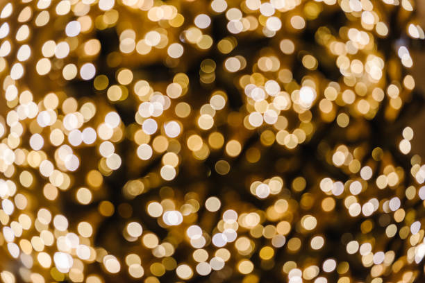 istock Yellow abstract blur bokeh made from Christmas light on black isolated background. Bokeh lights. Greeting card. Happy New Year 2024. Beautiful holiday billboard or festive glowing golden wall. Closeup 1738826204