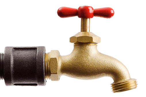 A brass water pipe faucet with a red tap handle knob, a household metal plumbing fixture, isolated on a white background.