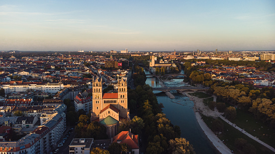 Panorama of evening Munich at sunset, view of the Isar River, and Kath. Pfarramt St. Maximilian