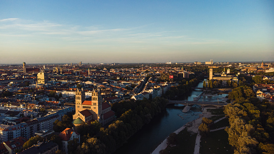 Panorama of evening Munich at sunset, view of the Isar River, and Kath. Pfarramt St. Maximilian