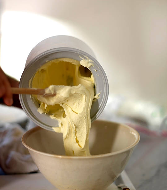 Home made Ice cream Removing vanilla ice cream from a home ice cream maker.  an outtake from an ice cream book. homemade icecream stock pictures, royalty-free photos & images