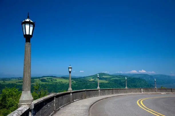 Streetlamps along Old Columbia River Gorge Highway near Vista House under a clear blue sky