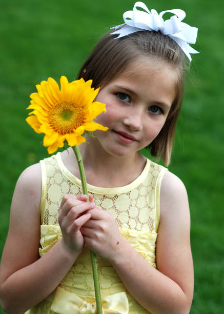 istock Little Girl with Sunflower 173884149