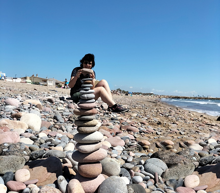 Making a pyramid of stones on the seashore