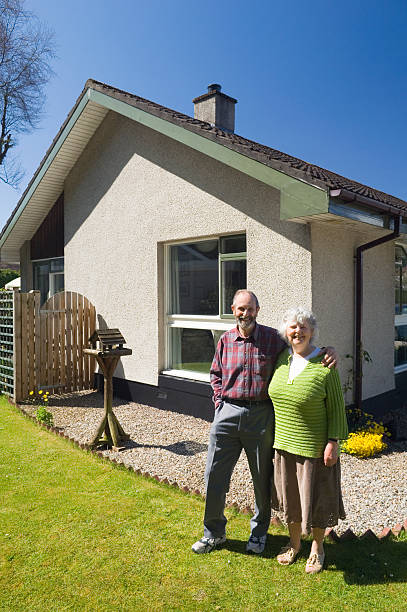 istock Senior couple outside their home 173884757