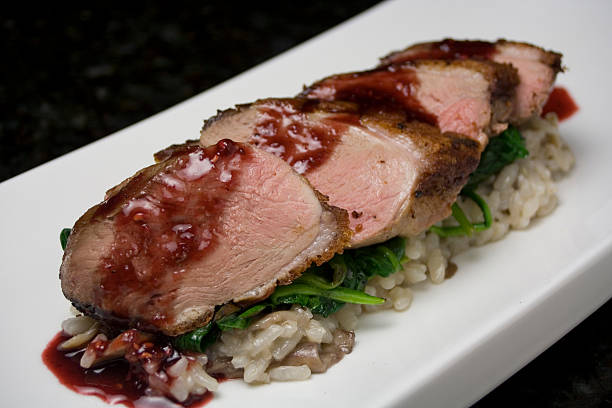 Duck Breast served over risotto with a blackberry reduction.